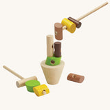 The PlanToys Stacking Logs Game on a plain background, some pieces are on the sticks and some are on the base. 