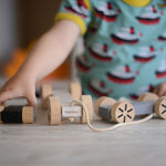A child playing with the Plan Toys Stacking Wheels. 