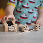 A child playing with the Plan Toys Stacking Wheels. 
