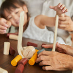 woman and young girl sat at a table playing with the PlanToys plastic-free wooden beaver tumble game