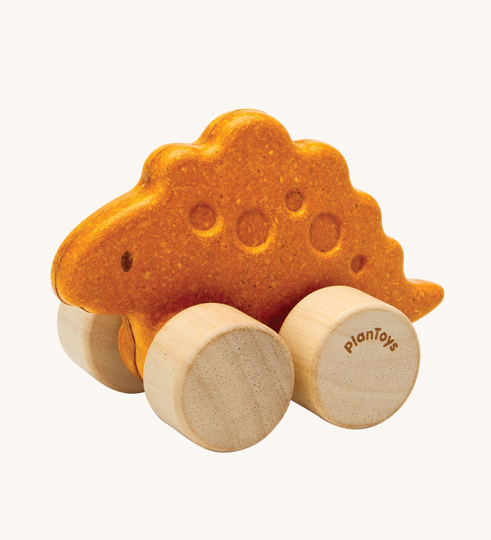 PlanToys Stego Dino wooden Car toy. A yellow coloured stegosaurus dinosaur figures on wheels. PlanToys range of toys are made from sustainably sourced rubberwood, we're proud stockists of PlanToys here at Babipur. 