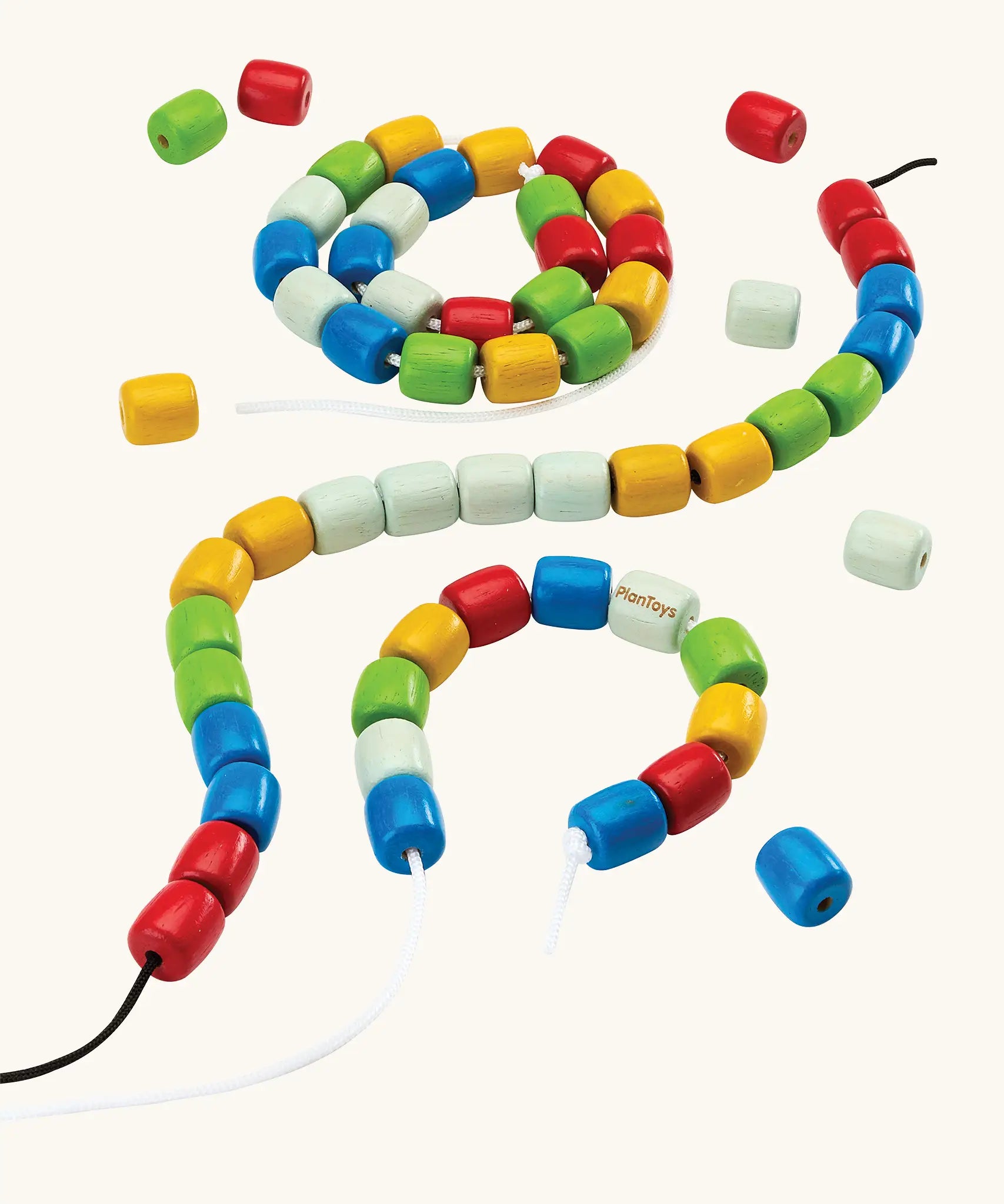 PlanToys threading beads wooden lacing toy. Rainbow coloured wooden beads threaded onto black and white laces.