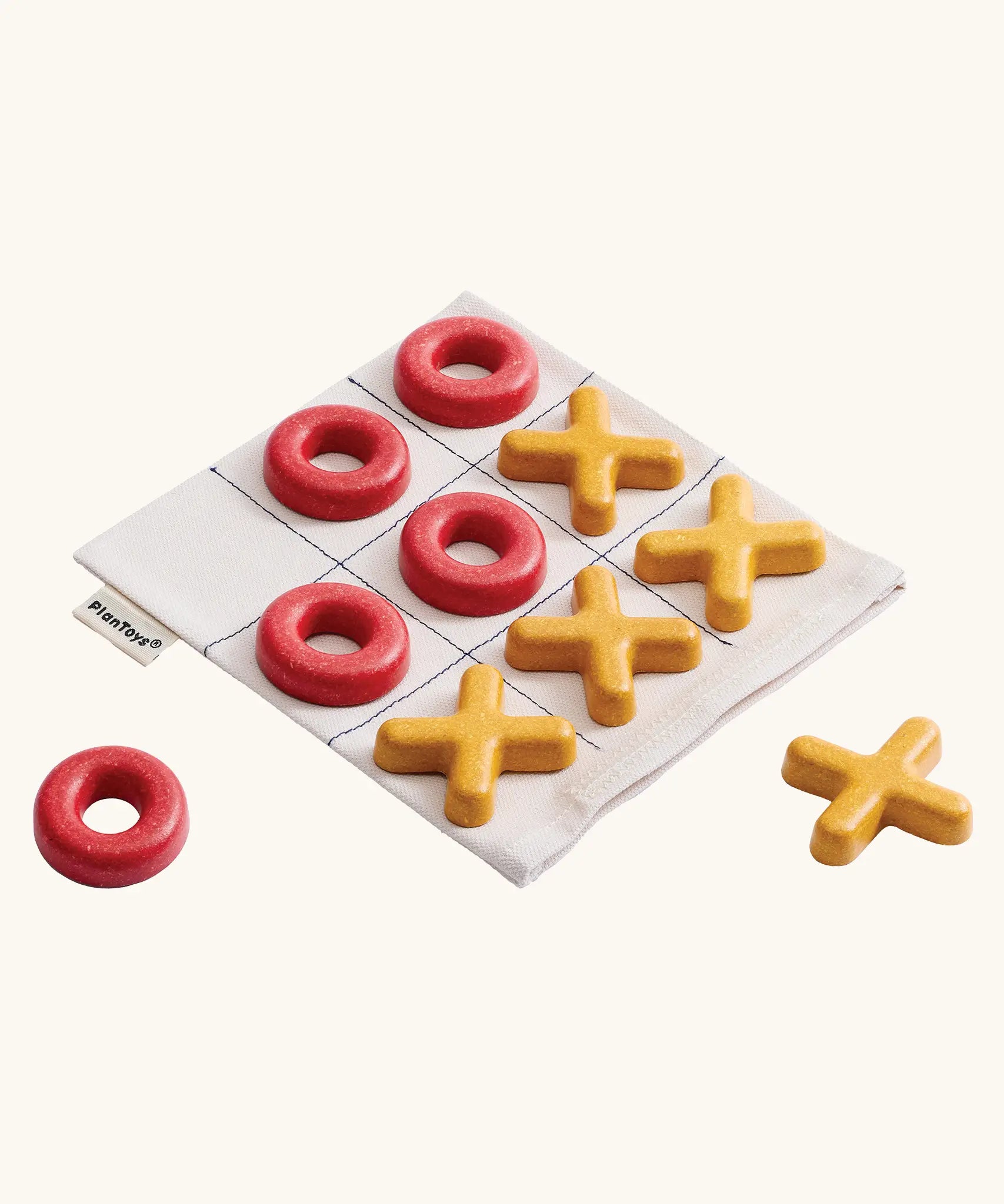 PlanToys Travel Tic-Tac-Toe wooden game set. Cotton storage bag printed with a grid with 5 yellow x pieces and 5 red o pieces.  