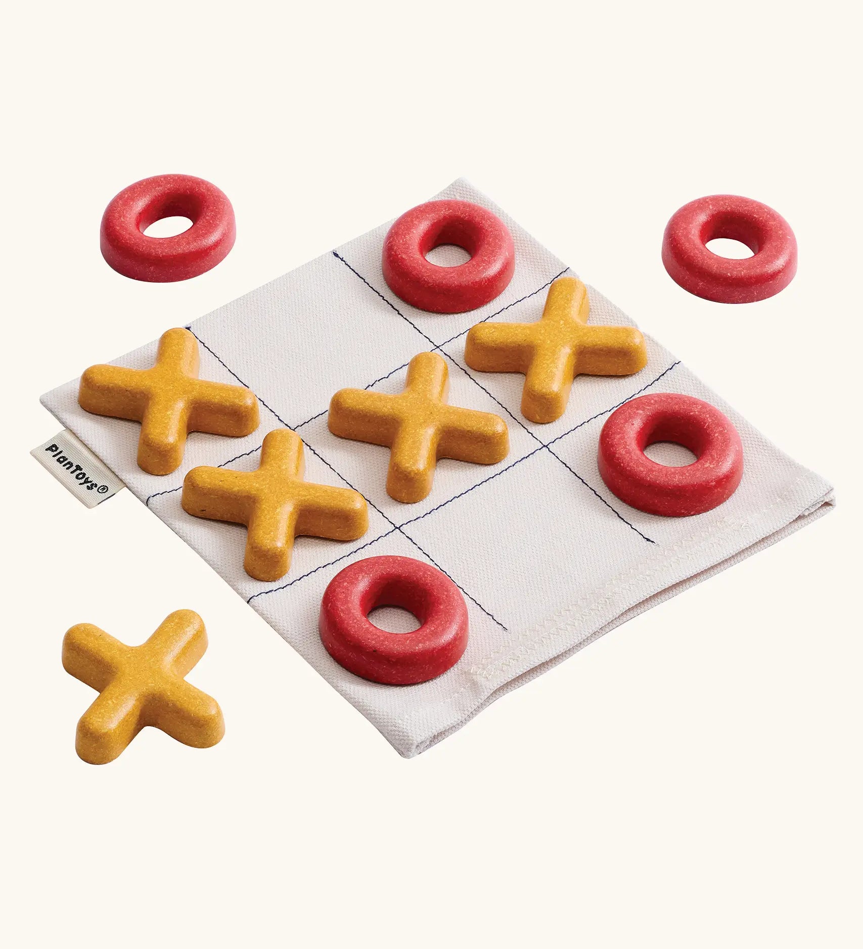 PlanToys Travel Tic-Tac-Toe wooden game set. Cotton storage bag printed with a grid with 5 yellow x pieces and 5 red o pieces.  