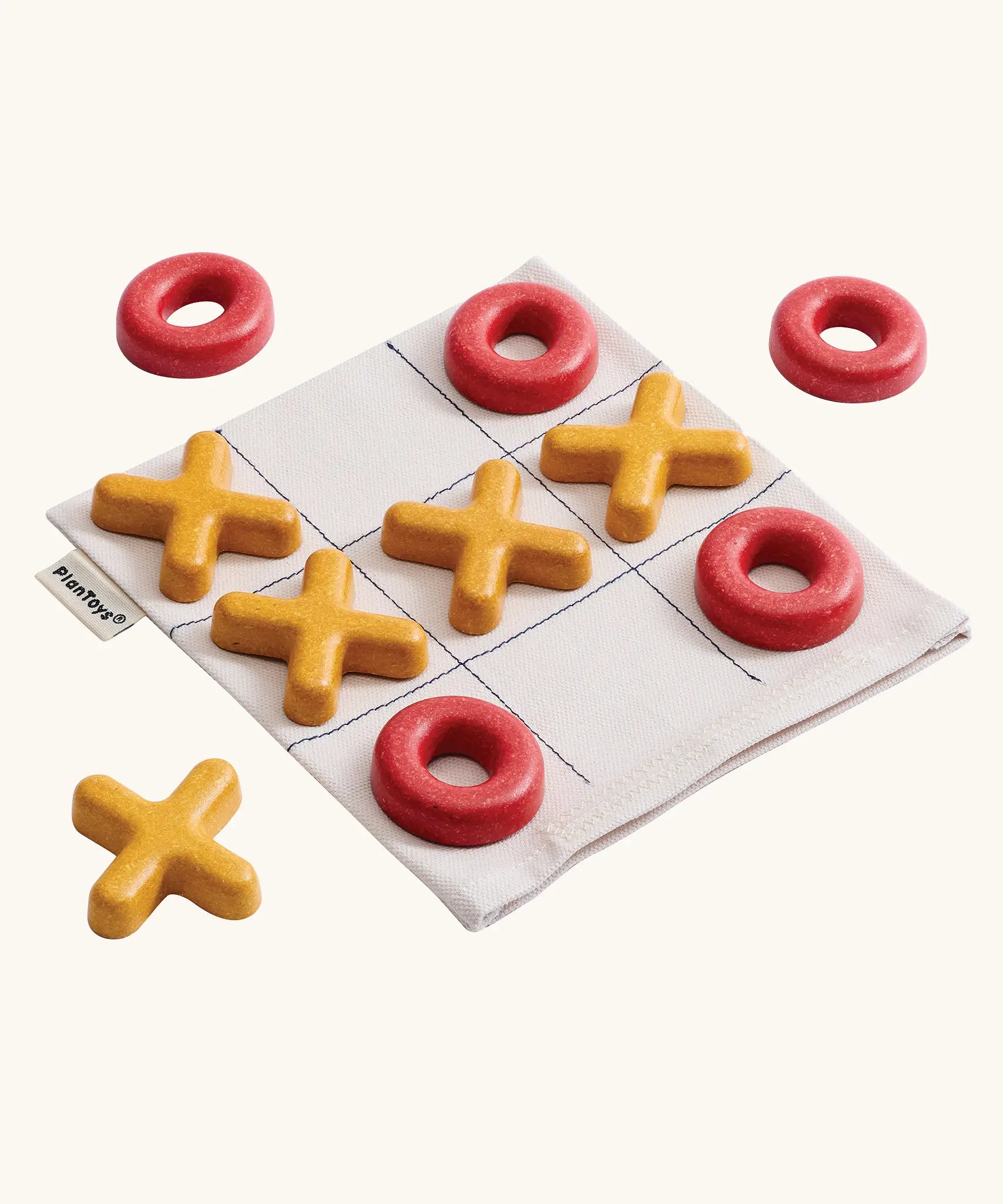 PlanToys Travel Tic-Tac-Toe wooden game set. Cotton storage bag printed with a grid with 5 yellow x pieces and 5 red o pieces.  
