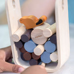 A close up of a child playing with the PlanToys Timber Tumble Game. 