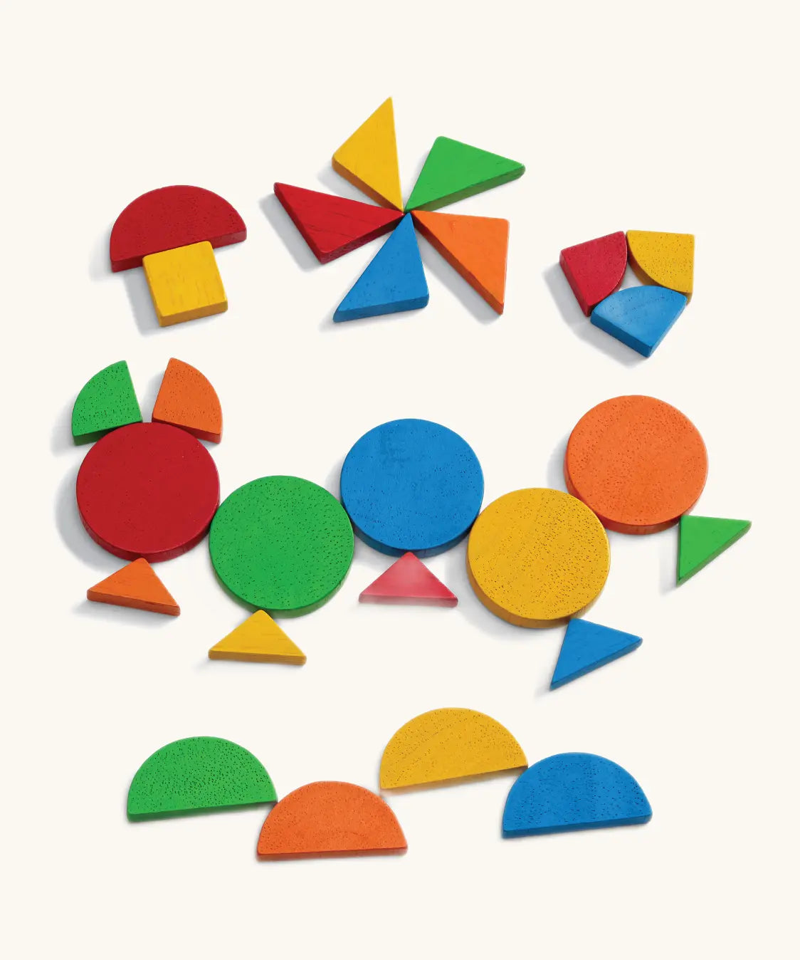 Girl arranging colourful mosaic shapes at a table near a dolls' house