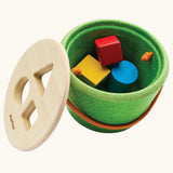 Nursery group setting with children sharing shape sorting toys