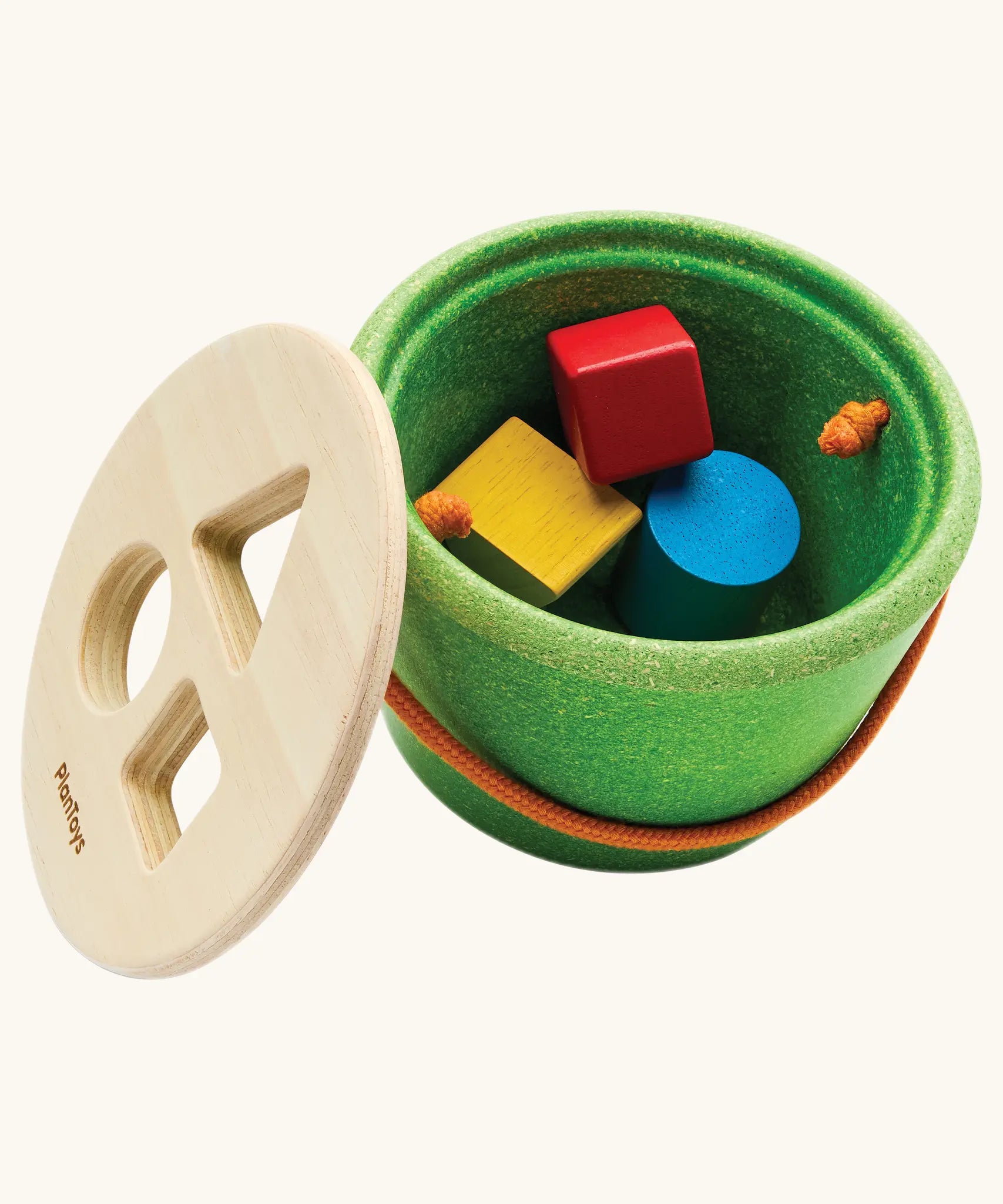 Nursery group setting with children sharing shape sorting toys