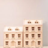PlanToys Grand Victorian Dollhouse pictured next to the smaller standard size house.