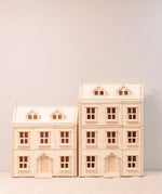 PlanToys Grand Victorian Dollhouse pictured next to the smaller standard size house.