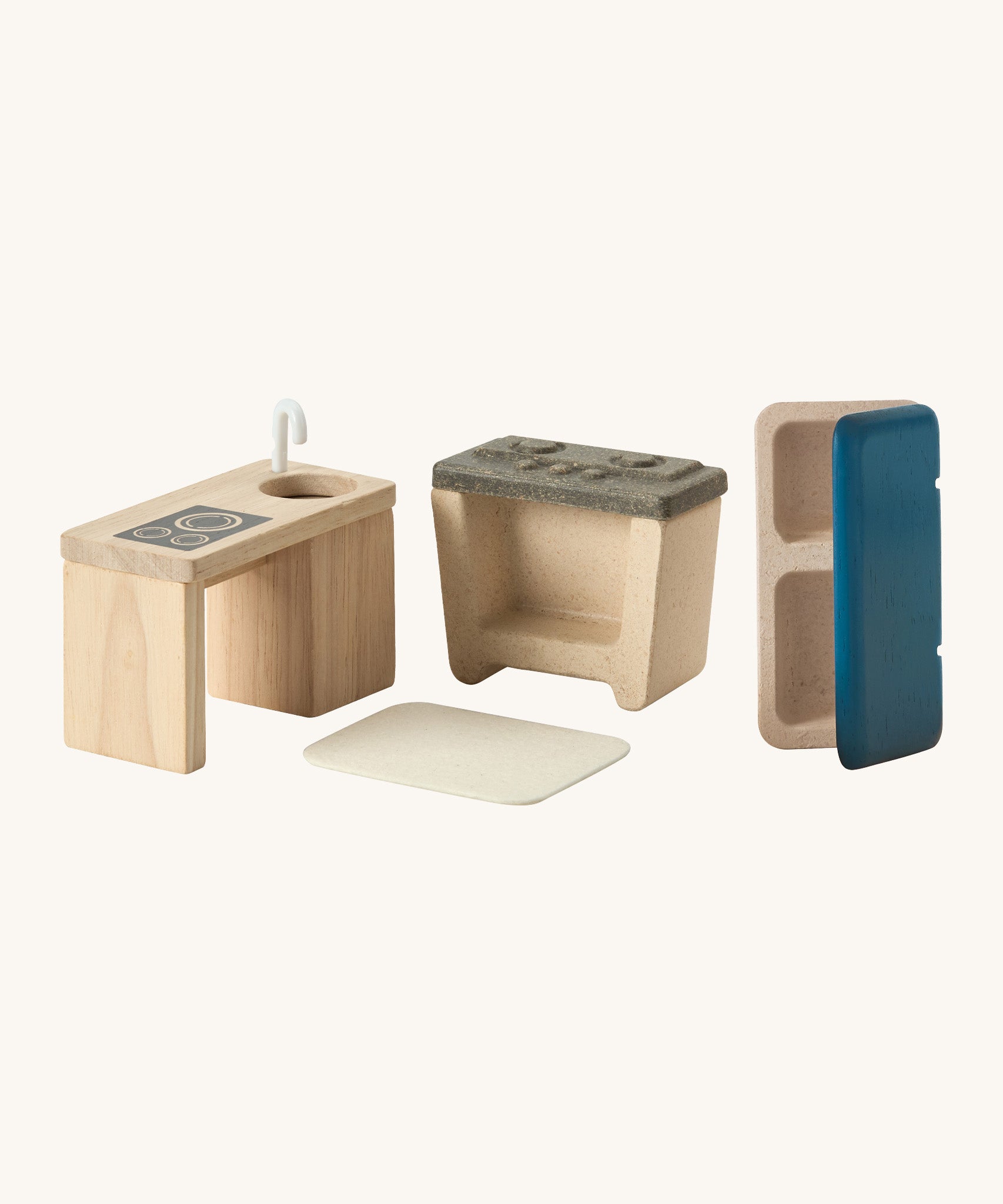 A close up view of the other PlanToys wooden dollhouse kitchen living room accessories including a sink, oven, fridge and a small rug 