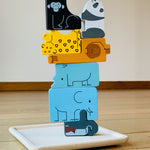 The pieces from the PlanToys Animal Puzzle Game
stacked up on the wooden base that comes with the game.