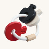 PlanToys wooden baby key rattle toy in a high contrast colourway. This baby toy has three wooden keys in white, red and black strung onto a white rope hoop. PlanToys range of toys are made from sustainably sourced rubberwood, we're proud stockists of PlanToys here at Babipur. 