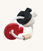 PlanToys wooden baby key rattle toy in a high contrast colourway. This baby toy has three wooden keys in white, red and black strung onto a white rope hoop. PlanToys range of toys are made from sustainably sourced rubberwood, we're proud stockists of PlanToys here at Babipur. 