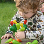 A child playing with the PlanToys Balancing Cactus.