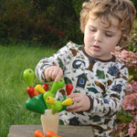 A child playing with the PlanToys Balancing Cactus. 
