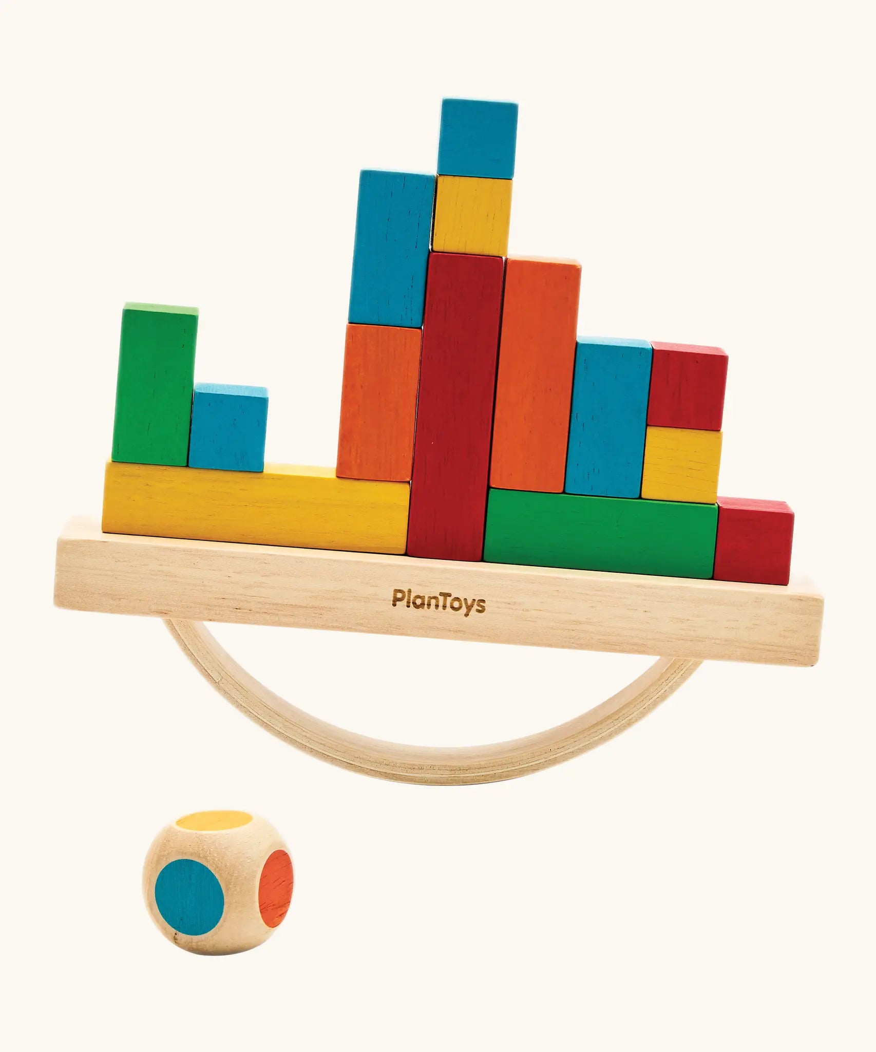 Close-up of hands carefully stacking cargo blocks onto the rocking base