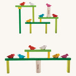 The PlanToys Balancing Tree stacked up in different ways. The stacks are platform like structures with the birds sitting at different points. 
