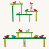 The PlanToys Balancing Tree stacked up in different ways. The stacks are platform like structures with the birds sitting at different points. 
