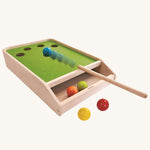 The PlanToys Ball Shoot Board Game on a plain background. Motion can be seen as the cue hits the yellow coloured ball. 