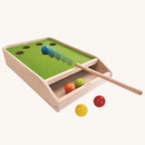 The PlanToys Ball Shoot Board Game on a plain background. Motion can be seen as the cue hits the yellow coloured ball. 