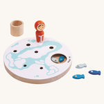PlanToys Ice Fishing Game on a plain background. Some of the fish can be seen inside the base and some by the side of the base.