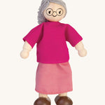 The PlanToys Grandmother Doll on a plain background. 
