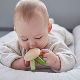 Close up of a baby holding the PlanToys flexi jellyfish baby teething toy close to its mouth
