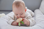 Close up of a baby holding the PlanToys flexi jellyfish baby teething toy close to its mouth