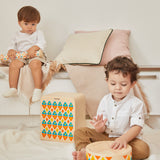 2 children sat down playing with the PlanToys solid wooden musical drum toy