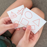 playing with the PlanToys sensory touch and guess game on a grey sofa