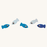 The Blue coloured fishes from the PlanToys Ice Fishing Game on a plain background. The fish are in various shades of blue. 