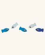 The Blue coloured fishes from the PlanToys Ice Fishing Game on a plain background. The fish are in various shades of blue. 