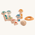 The PlanToys Meerkat Bowling Set on a plain background. Motion can be seen as the red and green meerkats are being bowled over.