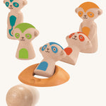 The PlanToys Meerkat Bowling Set on a plain background, the blue and red meerkats have been bowled over. 