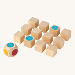 The PlanToys Mini Memo Game on a plain background. The cubes have all been turned to the black sides apart from two showing matching blue dots. 