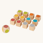 The PlanToys Mini Memo Game on a plain background. The pieces are all showing the coloured sides of the cubes. 

