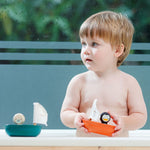 Plan Toys Penguin Sailing Boat being played with. 