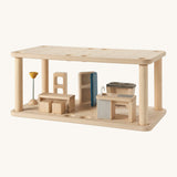PlanToys wooden space kitchen/dining set up. Features wooden toy kitchen accessories including a table, lamp, chairs, sink and fridge that can open