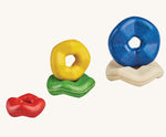 The pieces from the Plan Toys wooden Wave Stacker placed on top of each other. 