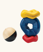 PlanToys wave ball stacker wooden stacking toy. Blue, yellow and red wavy rings with a black and white ball. 