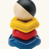 Baby experimenting with balance while stacking the wave rings