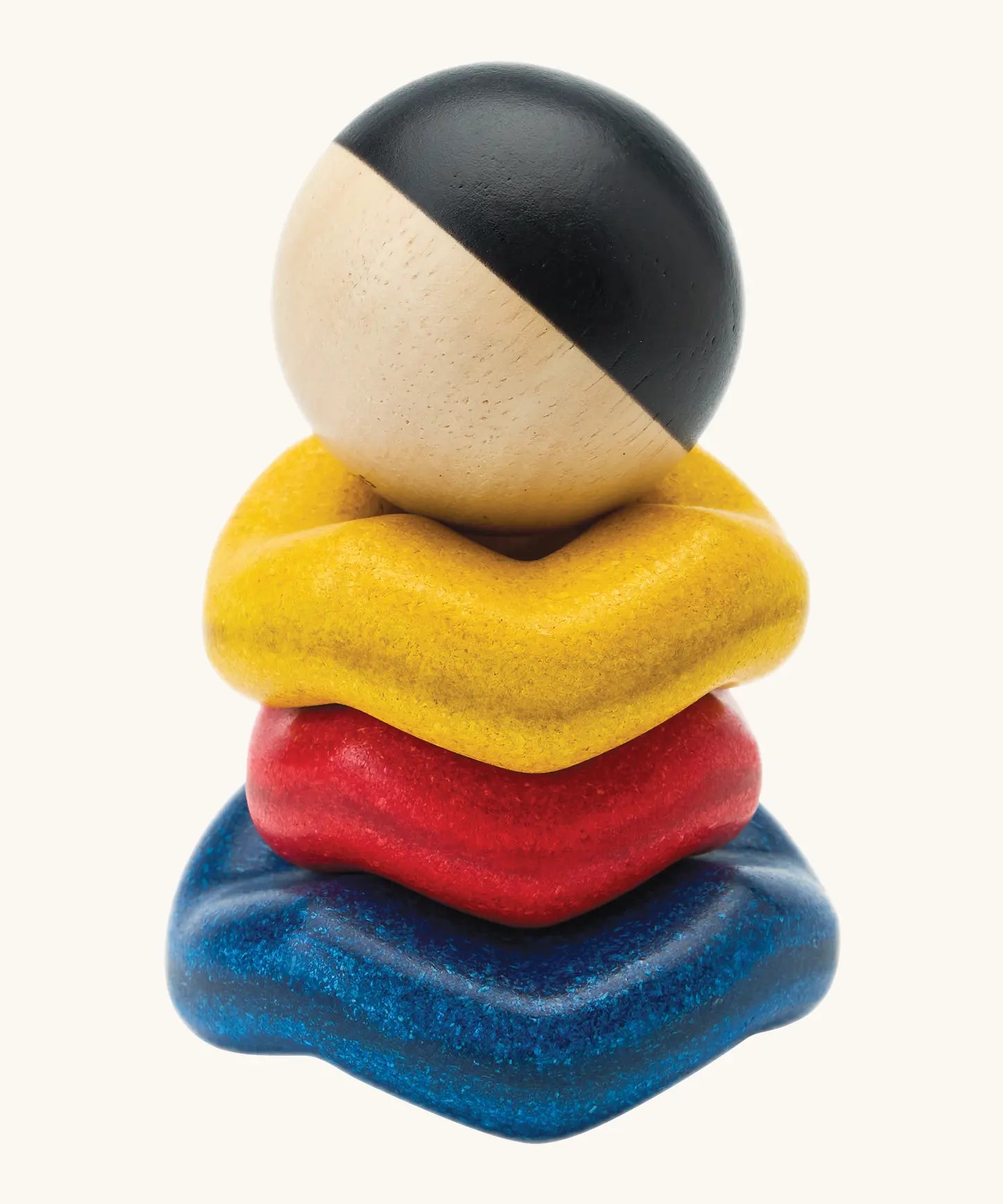 Baby experimenting with balance while stacking the wave rings