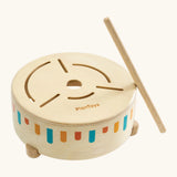Adult helping a toddler play the wooden sensory drum