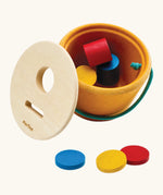 PlanToys drop and fit bucket wooden object permanence toy with the lid taken off.