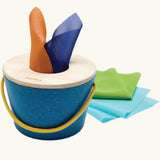 Baby pulling a coloured fabric scarf from the tissue box toy