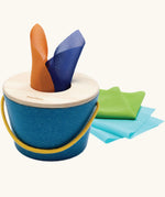 Baby pulling a coloured fabric scarf from the tissue box toy