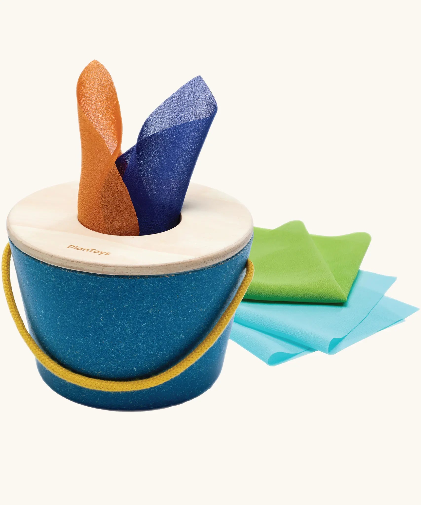 Baby pulling a coloured fabric scarf from the tissue box toy
