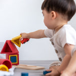 next to 3 stacks of PlanToys matching and nesting blocks